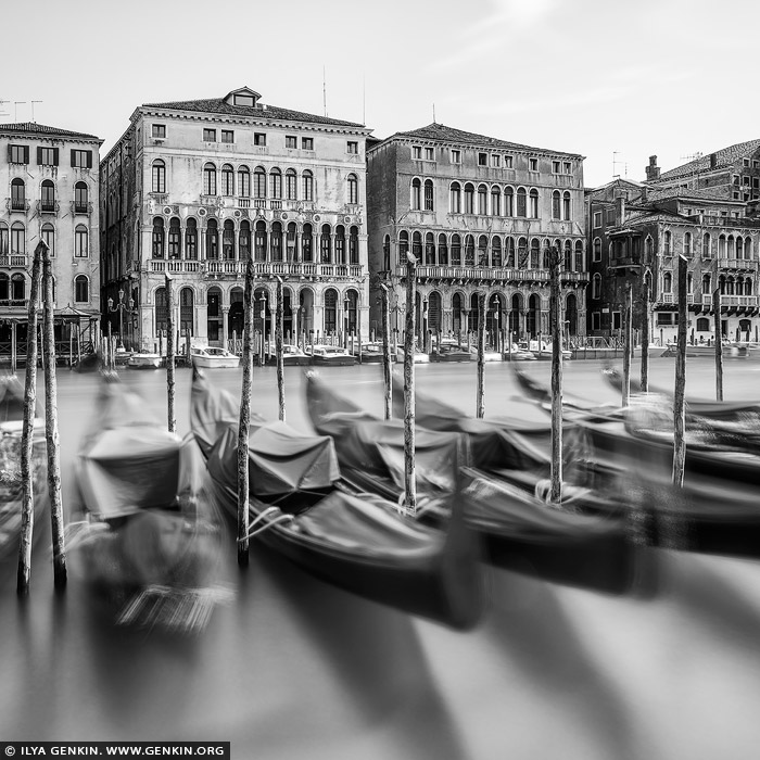 italy stock photography | Venice Grand Canal, Study 3, Venice, Veneto, Italy. Elegance drifts across time in this black-and-white long exposure of Venice's Grand Canal. Moored gondolas sway gently in blurred motion, their iconic silhouettes ghostlike against the still water, evoking the city's ceaseless rhythm. Behind them, the regal facades of historic palazzi - lined with columns, arches, and timeworn textures - stand in quiet contrast, frozen in architectural splendor. This poetic image captures the tension between movement and stillness, between the living flow of the canal and the enduring presence of Venetian grandeur. A timeless portrait of a city where water and stone dance in harmony.