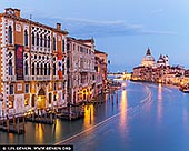  stock photography | The Grand Canal at Ponte dell'Accademia at Dusk, Venice, Veneto, Italy, Image ID ITALY-VENICE-0012. As dusk descends over Venice, the Grand Canal transforms into a glowing ribbon of light and motion. The ornate facade of Ca' d'Oro and neighboring palazzi bask in the soft blue of twilight, their gothic and Renaissance details illuminated by golden lamplight. In the distance, the majestic dome of Santa Maria della Salute anchors the skyline, glowing like a beacon at the canal's curve. Light trails from passing boats paint graceful arcs across the water, capturing the quiet energy of an evening in La Serenissima. This scene is Venice at its most magical - elegant, storied, and alive with subtle movement.