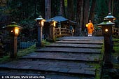  stock photography | Monk Walking at the Okunoin Cemetery, Mount Koya, Wakayama Prefecture, Japan, Image ID JAPAN-KOYASAN-OKUNOIN-0002. Koyasan, or Mount Koya, is the site of the headquarters of Japanese Shingon Buddhism. Its mountains are located to the south of Osaka in Wakayama Prefecture and are home to various ancient structures, including more than one hundred temples and the largest graveyard in the country. Today, Koyasan is a very popular pilgrimage destination for those looking to learn more about the religion's history, experience temple lodging and enjoy beautiful and picturesque scenery. While the precincts of the Koyasan temple complex are a fascinating destination even by day, they become even more intriguing and atmospheric after the sun goes down. Soak up history and mystique as you wander through the Okuno-in cemetery at night. This is a unique opportunity to experience Koyasan's spiritual side at a time when all of the other tourists have gone home.