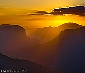 landscapes stock photography | Beautiful Sunrise at Govett's Leap Lookout, Blackheath, Blue Mountains National Park, NSW, Australia, Image ID AU-GOVETTS-LEAP-0002. A vivid sunrise lights the morning sky above the beautiful Govett's Leap lookout in Blackheath and Grose Valley in Blue Mountains National Park in NSW, Australia. Rays of light streak down through the clouds and blue haze of vapours from eucalyptus leaves.