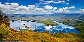 landscapes stock photography | Lake Burragorang, Blue Mountains, NSW, Australia, Image ID AU-LAKE-BURRAGORANG-0001. Panoramic view over Lake Burragorang in the lower Blue Mountains of New South Wales, Australia. McMahons Lookout offers splendid, unspoilt views across the backwaters Lake Burragorang, Sydney's man-made water supply dammed reservoir which supplies 80% of Sydney's precious water supply. This is a rare look at a different side of the Blue Mountains. Far to the south are the region's sandstone cliffs but in the foreground, smudged with the distinctive blueness of the mountains, are low-lying, rolling hills covered with eucalypts. And below is the drowned river valley with the occasional hilltop, still covered with trees, rising from the waters.