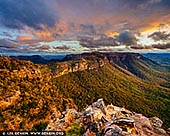 landscapes stock photography | Stormy Evening at Narrow Neck Plateau, Katoomba, Blue Mountains National Park, NSW, Australia, Image ID AU-NARROW-NECK-MEGALONG-VALLEY-0002. The Narrow Neck Plateau, an eroded remnant of a sandstone layer situated at an elevation of 1,000 metres (3,300 ft) above sea level that is part of the Blue Mountains Range which is a spur line off the Great Dividing Range, is situated immediately south-west of Katoomba in New South Wales, Australia, located within the Blue Mountains National Park. The neck separates the Jamison Valley (to the east) from the Megalong Valley (to the west). From Cliff Drive, Katoomba, the Narrow Neck is accessed via a dirt road called Glenraphael Drive suitable for most two-wheel drive vehicles, subject to good weather conditions, as far as a locked gate. It is a popular walking, bike riding and climbing location and offers several walking descent routes to the adjacent valleys. Beyond the gate is walking/bicycle access only for the general public. One of the most popular walks is the Golden Stairs, a rough descent of approximately 200 metres (660 ft) to join the Federal Pass. This opens up the Jamison Valley for popular day walks to sites such as Mount Solitary and the Ruined Castle. The neck juts southwards from Katoomba for a distance of some 10 kilometres (6.2 mi) and ends at Clear Hill, overlooking the Wild Dog Mountains. Castle Head promontory points towards the Ruined Castle, a small rock formation between Castle Head and Mount Solitary. Arguably one of the best views on the eastern seaboard of NSW is from Narrow Neck Fire Tower. On a day of high visibility it is possible to see from Mittagong in the south to Toronto in the north and a number of peak landforms in between. It also has excellent views back towards the escarpment at Katoomba.