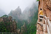 landscapes stock photography | Looking Down Xihai (West Sea) Canyon, Huangshan (Yellow Mountains), Anhui Province, China, Image ID CHINA-HUANGSHAN-0019. Female tourist looking at the clouds covered the magnificent Xihai Grand Canyon (West Sea Grand Canyon) from a lookout on a way down to the bottom of Xihai (West Sea) Grand Canyon.