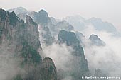 landscapes stock photography | Clouds Covered Huangshan Peaks, Cloud-dispelling Pavilion, Xihai (West Sea) Grand Canyon, Baiyun Scenic Area, Huangshan (Yellow Mountains), China, Image ID CHINA-HUANGSHAN-0020. Stock image of the cloud formations hover around the Huangshan mountain range and above the forest in Anhui Province of China.