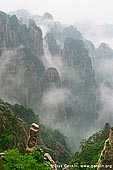 landscapes stock photography | View from Cloud-dispelling Pavilion, Xihai (West Sea) Grand Canyon, Baiyun Scenic Area, Huangshan (Yellow Mountains), China, Image ID CHINA-HUANGSHAN-0021. Stock photo of the cloud formations hover around the Huangshan mountain range and above the forest in Xihai Grand Canyon (West Sea Grand Canyon) in Anhui Province of China as it was seen from the Cloud-dispelling Pavilion.