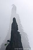 landscapes stock photography | Sharp Peaks of Huangshan Mountains in Mist , Xihai (West Sea) Grand Canyon, Baiyun Scenic Area, Huangshan (Yellow Mountains), China, Image ID CHINA-HUANGSHAN-0022. Almost black-and-white silhouette of two sharp peaks in Mount Huangshan National Park in Anhui Province of China.