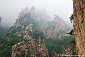 landscapes stock photography | Looking Up from the Bottom of the Xihai (West Sea) Grand Canyon, Baiyun Scenic Area, Huangshan (Yellow Mountains), China, Image ID CHINA-HUANGSHAN-0023. Stock image of the high peaks of the Xihai Grand Canyon (West Sea Grand Canyon) and stone walking path on the side of the cliffs in Huangshan (Yellow Mountains) in Anhui Province of China.