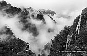 landscapes stock photography | Huangshan Mountains in Clouds, Cloud-dispelling Pavilion, Xihai (West Sea) Grand Canyon, Baiyun Scenic Area, Huangshan (Yellow Mountains), China, Image ID CHINA-HUANGSHAN-0032. Black and white photo of the cloud formations hover around the Huangshan mountain range and above the Xihai (West Sea) Canyon in Anhui Province of China.