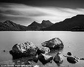 landscapes stock photography | Cradle Mountain and Lake Dove, Cradle Mountain National Park, Tasmania, Australia, Image ID CRADLE-MOUNTAIN-LAKE-DOVE-TAS-0004. Black and white photo of Cradle Mountain and the Lake Dove in the Cradle Mountain National Park, Tasmania, Australia. Clouds moving fast above the mountings creating dramatic view.