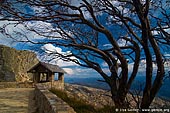 landscapes stock photography | Old Stone Hut and View over Australian Alps from The Horn, Mount Buffalo National Park, Victoria, Australia, Image ID MOUNT-BUFFALO-VIC-0007. Stock photo of the old rock built hut nicely surrounded by a curved dry tree at the starting point of the Horn mountain summit walking in Mount Buffalo National Park, Victoria Hight Country, Australia.