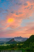 landscapes stock photography | Mount Warning at Sunrise, The Northern Rivers, NSW, Australia, Image ID AU-MOUNT-WARNING-0002. Dominating the lush Tweed Valley in New South Wales is Mt Warning. Its tilted summit curiously regards the famous surf breaks at Byron Bay well as hinterland towns such as joyful Uki, 1156m Wollumbin-Mt Warning in Wollumbin National Park attracts a year-round procession of boot-clad admirers. The mountain, a remnant central vent of an ancient volcano, receives Australia's first rays of sunlight; to catch that early glow, some torch-wielding visitors begin the 9km, five-hour return hike in darkness. If you prefer starting and finishing in daylight, make sure to set out prior to 1pm in winter. Either way, mentally prepare yourself for the final section, which involves scrambling up a steep, rocky slope, using a chain for assistance.