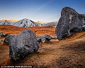 landscapes stock photography | Castle Hill at Dawn, Canterbury Region, South Island, New Zealand, Image ID NZ-CASTLE-HILL-0004. The Castle Hill boulders are a 10 minute walk from the Great Alpine Highway 73, between Springfield and Arthur's Pass in Canterbury Region, South Island, New Zealand. The formations rear up from the grasslands and to the early European settlers, they resembled old run-down castles, hence the name. It is easy to spend hours wandering among this extensive area, admiring arches, towers, holes, slabs and other shapes that inspire your imagination.