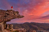 landscapes stock photography | Sunset at the Balconies Lookout (Jaws of Death), The Grampians National Park (Gariwerd), Victoria, Australia, Image ID GRAMPIANS-0011. A female tourist in a casual sports outfit overlooking the Grampians National Park (Gariwerd) and watching amazing sunset from the Balconies Lookout (Jaws of Death) in Victoria, Australia.