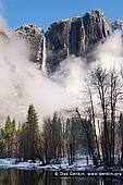 landscapes stock photography | Upper Yosemite Falls and Merced River After a Spring Snow Storm, Yosemite Valley, Yosemite National Park, California, USA, Image ID YOSEMITE-NATIONAL-PARK-CALIFORNIA-USA-0005. Upper Yosemite Falls from Swinging Bridge over the Merced River after a spring snowstorm with a cloud at its base in the Yosemite Valley of the Yosemite National Park, California, USA.