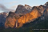 landscapes stock photography | Bridalveil Falls from Tunnel View, Yosemite National Park, California, USA, Image ID YOSEMITE-NATIONAL-PARK-CALIFORNIA-USA-0006. Closeup view of Bridalveil Fall and the Cathedral Rocks from Tunnel View at sunset when the last rays of the Sun highlighted the waterfall. Bridalveil Fall is one of the iconic waterfalls of Yosemite Valley. The waterfall is 620ft height and is one of the few waterfalls in the park that flows year-round.