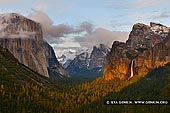 landscapes stock photography | Yosemite Valley and Bridalveil Falls at Sunset from Tunnel View, Yosemite National Park, California, USA, Image ID YOSEMITE-NATIONAL-PARK-CALIFORNIA-USA-0008. Classic View of the Yosemite Valley and Bridalveil Falls from Tunnel View at sunset when the last rays of the sun perched through the clouds and highlighted the valley. Tunnel View, within Yosemite National Park, is a viewpoint on State Route 41 located directly east of the Wawona Tunnel as one enters Yosemite Valley from the South. The view looks east into Yosemite Valley including the southwest face of El Capitan, Half Dome, and Bridalveil Falls. This is, to many, the first views of the popular attractions in Yosemite. Many cars stop right outside of the tunnel to take pictures and absorb the visual aesthetics.