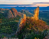 landscapes stock photography | The Breadknife and Warrumbungles at Sunrise, Warrumbungle National Park, New South Wales (NSW), Australia, Image ID AU-WARRUMBUNGLES-0004. The Warrumbungle National Park is one of the most diverse national parks in Australia with a never ending amount of beautiful walks for bushwalkers plus stunning landscapes (and inky black nightscapes) for photographers. Carved out of rugged grazing country in 1953 and inscribed on the National Heritage List in 2006, Warrumbungle National Park is a visual feast with highlights that include towering volcanic features and myriad wildflowers that colour the landscape in spring. Since the 1930s it has been known as one of the state's best bushwalking destinations and some 30km of tracks scramble up, around and over the striking natural formations. The best walks among them are Belougery Split Rock, Macha Tor and the iconic Grand High Tops, all of which offer glorious views and take hikers past grazing kangaroos and woodlands alive with eastern spinebills, honeyeaters, currawongs, wattlebirds and the flashes of firetails.