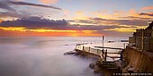 landscapes stock photography | Beautiful Sunrise at Bronte Baths, Bronte Beach, Sydney, NSW, Australia, Image ID AU-BRONTE-BEACH-0003. Bronte beach at the Bondi to Coogee walk and is great for swimmers and surfers alike. Bronte Beach is very scenic it makes for a nice getaway for the whole family. Bronte Beach is popular with surfers despite the often rough surf. You can swim at the 'bogey hole', a 30 metre ocean pool rock pool towards the southern end of the beach if you find the surf too challenging. Bondi to Bronte walk is one of the most popular walks in Sydney and one of the best Sydney's locations for photographing sunrises.