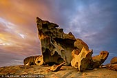 landscapes stock photography | Dramatic Sunrise at The Remarkable Rocks, Flinders Chase National Park, Kangaroo Island, SA, Australia, Image ID KI-REMARKABLE-ROCKS-0003. Nature has carved the well-named Remarkable Rocks in the Flinders Chase National Park on Kangaroo Island, SA, Australia. On top of a huge dome-shaped granite mound are many weirdly shaped granite boulders. Their cavernous shell like appearance is a result of rock being dissolved. Water collecting in cracks and on surfaces, is protected from sunlight and wind, and gradually weathers the rocks. The microscopic roots of the orange coloured lichen further contribute to this weathering. This is an Australian geographical oddity, attracting visitors from all over the world.