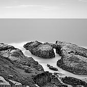 landscapes stock photography | The Arch at Indian Head, Crowdy Bay National Park, Mid North Coast, NSW, Australia, Image ID AU-NSW-DIAMOND-HEAD-0001. Crowdy Bay National Park, near Port Macquarie is a great coastal getaway. Offering beach camping, picnic areas, fishing spots and walking tracks, there is plenty to see and do. Diamond Head loop walk is the ideal introduction to the splendour of Crowdy Bay National Park, near Port Macquarie. Starting at Diamond Head campground, you'll link up with Headland walking track and Forest walking track for a walk packed with visual delights, which highlights why this park is a national treasure. Passing through heath and forests of paperbark and swamp mahogany, pause to take in the exceptional views at Kylies lookout and scan the waters for dolphins. It's thought that Diamond Head draws its name from the quartz crystals in the cliffs and you might see them sparkling in the sunlight. The headland rises dramatically and offers panoramic views across Crowdy Bay, north to Perpendicular Point and south to Crowdy Head. In between are superb sweeps of golden sand, and rising out of the lush forested hinterland, behind you, are the majestic Three Brothers mountains.