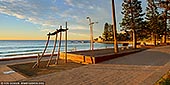 landscapes stock photography | Dee Why Beach Corso at Sunrise, Dee Why, Sydney, NSW, Australia, Image ID AU-DEE-WHY-BEACH-0002. Dee Why Beach Corso has been stylishly designed with a mix of stainless steel street furniture, picnic tables, elegant looking lamp posts and shower units. Breakfast at Dee Why Beach, at one of the cafes on the beachside strip, is a great way to start the day. A promenade, grass picnic stretch and road separates the cafes from the soft sands but does not detract from the views of the glistening seas. Most cafes offer both alfresco and inside dining.