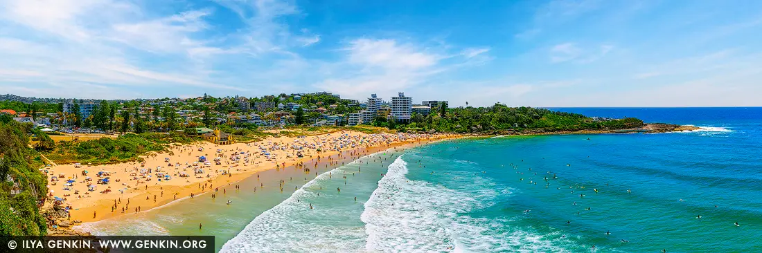 Surf and Sun at Freshwater Beach - Fine art print of Sydney, NSW, Australia - A quintessential slice of Australian summer, Freshwater Beach comes alive under the glow of a brilliant midday sun. Golden sands ripple with footprints as umbrellas dot the shore and swimmers wade through the shallows, while beyond the break, a lively swell draws dozens of surfers riding the rolling Pacific waves. Cradled between headlands and backed by a vibrant coastal community, this iconic Northern Beaches destination radiates energy, warmth, and surfside spirit. The scene brims with life - a celebration of beach culture and natural beauty - perfect for infusing any living room, office, or holiday space with the joy and movement of summer by the sea. - Image ID: AU-FRESHWATER-BEACH-0004