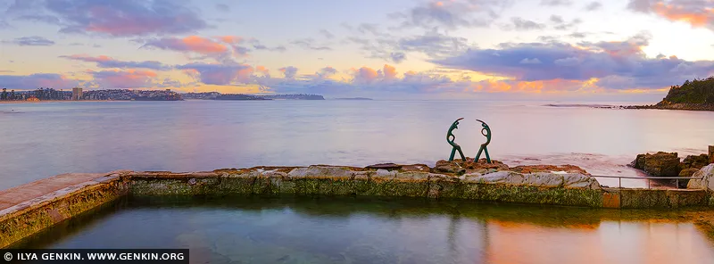 landscapes stock photography | Quiet Communion, The Fairy Bower pool in Manly, Sydney, NSW, Australia. At first light, the Oceanides stand in silent conversation above the tidal pool, their curved forms echoed by the softened horizon. Blush pink, lavender and pale gold move gently across sea and sky, bringing a sense of stillness, emotional balance and expansive breathing room into daily life. As a commanding design anchor, this panoramic artwork introduces refined coastal colour to residential interiors, executive offices and sophisticated hospitality spaces. Its cool blue-violet tones settle beautifully into natural light, while the warmer sunrise accents lend quiet radiance; presented in a commanding, large-format museum presentation, the scene truly comes alive, widening the visual boundaries of the room.