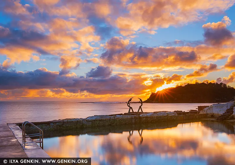 landscapes stock photography | Ember Reverie, The Fairy Bower pool in Manly, Sydney, NSW, Australia. A radiant hush settles across the room through this dawn-lit seascape, where molten gold, soft apricot and tranquil blue dissolve into still water and open sky. Living alongside this scene brings a sense of spacious calm and quiet renewal, as though the first light of day has been invited indoors to soften the mind and steady the rhythm of a home. As a commanding visual focal point, this work anchors refined residential interiors, executive offices or coastal-inspired spaces with both warmth and poise. Its luminous tones shift beautifully with natural light on the wall, moving from gentle glow to rich evening depth, and in a large-format museum presentation, the scene truly comes alive - expanding the perceived boundaries of the room while lending it a cultivated, immersive presence.
