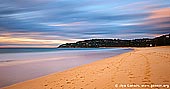 landscapes stock photography | Palm Beach at Sunrise, Palm Beach, Sydney, NSW, Australia, Image ID PALM-BEACH-BARRENJOEY-0003. This view of sandy Pacific coastline was taken at sunrise and it shows Palm Beach of the Sydney's Northern Beaches, Australia. Colours of yellow and pink stream across moving clouds in the morning sky.