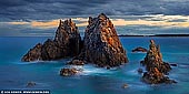 landscapes stock photography | Camel Rock at Sunset, Bermagui, Sapphire Coast, NSW South Coast, NSW, Australia, Image ID AU-BERMAGUI-CAMEL-ROCK-0002. Without a doubt, the South Coast of NSW has some of the most unique and iconic seascape formations in the world. One of these rock formations is the Camel Rock. Camel Rock is small outcrop at the far end of a long sandy beach near the beautiful little seaside town of Bermagui in NSW, almost as far south as you can get before ending up in Victoria. You really have to have a vivid imagination to see this rocky outcrop as a camel. It looks more like a nesting emu and only from the beach. From all other places it's visible as three independent pyramid rocks, but it is worth visiting.