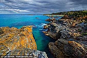 landscapes stock photography | Mystery Bay Coast after Storm, Mystery Bay, Eurobodalla, South Coast, NSW, Australia, Image ID AU-MYSTERY-BAY-0001. A dramatic nature coastline of rugged rocks near Mystery Bay on the far south coast of NSW, Australia right after the storm. Mystery Bay is a small town and a beautiful rocky bay located 15 kilometres south of Narooma. Is it a popular camping spot and it fronts the ocean and is one of the few natural camping areas remaining on NSW south coast. The elevated rocks offer fabulous scenic views out to the Pacific Ocean where you are likely to see whales during their spring migration.