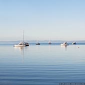 landscapes stock photography | Calm Morning at Coles Bay, Freycinet National Park, Tasmania (TAS), Australia, Image ID TAS-COLES-BAY-0002. Minimalistic landscape photography of tranquil waters of the Coles Bay, Tasmania, Australia with boats and yachts.