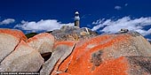 landscapes stock photography | Eddystone Point Lighthouse, Mount William National Park, Tasmania (TAS), Australia, Image ID TAS-EDDYSTONE-POINT-LIGHTHOUSE-0001. Panoramic photo of the Eddystone Point Lighthouse with lichen covered rocks in foreground. Tasmania's Eddystone Point Lighthouse resides almost as far North-East of the island in the Mount William National Park at the northern end of the Bay of Fires, known for its red lichen covered rocks which contrast against the deep blues of the sky or the Tasman Sea.