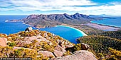 landscapes stock photography | Wineglass Bay from Mt Amos, Freycinet National Park, Tasmania (TAS), Australia, Image ID TAS-WINEGLASS-BAY-0001. Mount Amos is part of the range of granite mountains, known as the Hazards, which dominate Coles Bay and Freycinet Peninsula. The track to the summit is steep and strenuous, but walkers are rewarded with amazing panoramic views including famous Wineglass Bay in all its glory.