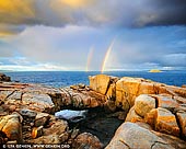 landscapes stock photography | Stormy Sunrise at the Natural Bridge, Torndirrup, Western Australia (WA), Australia, Image ID AU-WA-NATURAL-BRIDGE-0001. A visit to Albany is not complete without seeing the wonder of The Gap and The Natural Bridge, which are part of the amazing Albany's rugged Rainbow Coast. The Natural Bridge is a granite formation that looks just like a giant rock bridge. The natural bridge formation is a reminder of the power of the ocean. When there is a good swell in the ocean, you will see waves burst through under the bridge. Magnificent view of the ocean reaches way beyond the 'natural rock bridge' as you look at the horizon. You can stroll a little further to across the rocky surface and absorb the beauty of the bay and the rough cliffs. During the whale watching season which is from June to October each year when the whales migrate north to deliver their young, they can often be seen playing in the bay.