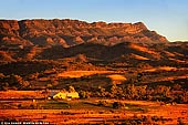 landscapes stock photography | Arkaba Station Woolshed at Sunrise, Flinders Ranges, SA, Australia, Image ID AU-SA-FLINDERS-0012. Arkaba Station is set amongst one of the most ancient landscapes on earth, in the Flinders Ranges. The area's geological history goes back to 700,000,000 years. The land rose and fell, the earth's crust moved and was broken, and parts forced together were pushed up to form mountain ranges. The Historic Arkaba Woolshed was built in 1856 and was used as a depot shed for the surrounding properties and retains its historic charm, it is still utilised as a working shearing shed. Last century it served as a depot shed with up to 40 blade shearers handling the flocks of many surrounding properties.