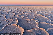 landscapes stock photography | Sunset at Lake Eyre, Kati Thanda - Lake Eyre National Park, South Australia (SA), Australia, Image ID AU-LAKE-EYRE-0001. Australia's largest salt lake, Lake Eyre - Kati Thanda has a catchment area from three states and the Northern Territory. The north lake itself is huge, covering an area 144km long and 77km wide, and at 15.2 metres below sea level, it is the lowest point in Australia. The south lake is 64km long and 24km wide. Flood waters cover the lake once every eight years on average. However, the lake has only filled to capacity three times in the last 160 years. You may feel a sense of isolation standing on the dry lake edge and seeing nothing as far as the eye can see. Sunrise and sunset are the best times to photograph the spectacular lake and desert country.