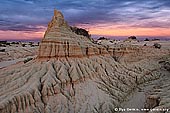 landscapes stock photography | Sunset at The Walls of China, Mungo National Park, NSW, Australia, Image ID AU-MUNGO-0022. Low sun painted clouds in the sky in pink, yellow and orange creating beautiful scene in Mungo National Park, NSW, Australia. The entire landscape picture of sand formations (the Walls of China) looks fantastic.