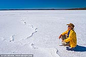 landscapes stock photography | Woman is Observing the Lake Gairdner, Gawler Ranges, South Australia (SA), Australia, Image ID AU-SA-LAKE-GAIRDNER-0011. Lake Gairdner is a huge endorheic lake in Outback South Australia. Endorheic lakes are bodies of water that do not flow into the sea. Most of the water falling on earth finds its way to the oceans through a network of rivers, lakes and wetlands. However, there is a class of water bodies that are located in closed or endorheic watersheds where the topography prevents their drainage to the oceans. When the Lake Gairdner is flooded it is considered the fourth largest salt lake in Australia after Lake Eyre, Lake Torrens and Lake Frome. The glistening white surface, surrounded by red hills and red beaches, is a beautiful sight. Along with Lake Everard and Lake Harris, the area is protected as Lake Gairdner National Park. The lake is over 160 km (100 miles) long and 48 km (30 miles) across with salt over 1.2 metres (4 ft) thick in some places. It is located west of Lake Torrens, 150 km northwest of Port Augusta and 440 km northwest of Adelaide. It is located in the Gawler Ranges.