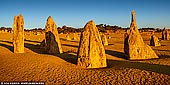 landscapes stock photography | The Pinnacles Desert at Sunset, Nambung National Park, WA, Australia, Image ID AU-NAMBUNG-PINNACLES-0001. The Pinnacles Desert is the most famous natural wonder of Western Australia, and the most popular attraction and holiday destination which draws hundreds of thousands of Aussie and international visitors each year. Part of Nambung National Park, the Pinnacles Desert is not only one of Australia’s most fascinating landscapes, it is one of the most fascinating landscapes in the world. Because of its otherworldly uniqueness, the Pinnacles Desert presents fantastic photo opportunities at sunrise and sunset. Another unique experience is seeing the Full Moon rise up out of the Pinnacles Desert as the sun sets into the Indian Ocean.