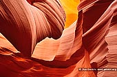 landscapes stock photography | Sandstone Interior of Lower Antelope Canyon, Navajo Tribal Park, Page, Arizona, USA, Image ID US-ARIZONA-ANTELOPE-CANYON-0005. Sunlight and blowing sand from the surface adds to the surreal and abstract shapes and colorful hues of Antelope Canyon in Navajo Tribal Park near Page, Arizona. Carved by millions of years of water and wind, the slot canyon is one of the most unique and beautiful geological wonders of the American West.