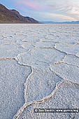 landscapes stock photography | Badwater at Twilight, Death Valley, California, USA, Image ID US-DEATH-VALLEY-0009. The salt flats in Badwater Basin in the Death Valley National Park in California, USA cover nearly 200 square miles, among the largest protected salt flats in the world. The vast, surreal salt flats of Badwater Basin change constantly. Salt crystals expand, pushing the crust of salt into rough, chaotic forms. Newly formed crystals ooze between mudcracks, sketching strange patterns on the surface of the salt flat. Passing rainstorms wash off windblown dust and generate a fresh layer of blinding white salt. Floods create temporary lakes that dissolve salts back into solution, starting the process all over again.