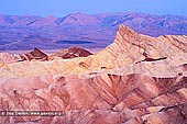 landscapes stock photography | Sunrise at Zabriskie Point, Death Valley, California, USA, Image ID US-DEATH-VALLEY-0002. First dawn light at Manly Peak (Manly Beacon) at Zabriskie Point in Death Valley National Park, California, USA, showing convolutions, texture, and color contrasts in the eroded rocks.