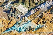 landscapes stock photography | Artist's Palette, Death Valley, California, USA, Image ID US-DEATH-VALLEY-0005. Artist's Palette in the Death Valley National Park, California, USA is on the face of the Black Mountains and is noted for having various colors of rock. These colors are caused by the oxidation of different metals (red, pink and yellow is from iron salts, green is from decomposing tuff-derived mica, and manganese produces the purple).