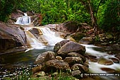 landscapes stock photography | Josephine Falls, Wooroonooran National Park, Queensland (QLD), Australia, Image ID QLD-JOSEPHINE-FALLS-0001. Josephine Falls are ranked among the most beautiful in the Tropical North Queensland, and have been used in many television commercials. They are located at the foot of the southern face of Mount Bartle Frere in the Wooroonooran National Park, in Queensland, Australia just 75 km south of Cairns. The falls are a popular recreation site among locals as the water flows over a large rock to form a natural waterslide. Visitors can swim in the crystal clear waters, and relax on the sandy beach as the gentle breeze rustles leaves high in the rainforest canopy.