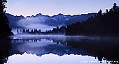 landscapes stock photography | Panorama of Lake Matheson at Sunrise, Lake Matheson, South Westland, South Island, New Zealand, Image ID NZ-LAKE-MATHESON-0006. Panorama of stunning Lake Matheson, also called Mirror Lake, on South Island of New Zealand at Sunrise. The Westland National Park is a beautiful area located on the South Island of New Zealand. This panoramic photo of Lake Matheson was taken with a view of Mt Tasman and Aoraki/Mt Cook reflected in Lake Matheson. The waters of Lake Matheson are dark brown, so on a calm day they create the ideal reflective surface. By a happy coincidence, Mt Tasman and Aoraki/Mt Cook are perfectly positioned to reflect in the lake.
