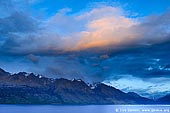 landscapes stock photography | Thomson Mountains and Lake Wakatipu at Dawn, Queenstown, Lakes District, Otago, South Island, New Zealand, Image ID NZ-LAKE-WAKATIPU-0004. Thomson mountains with dramatic clouds above at sunrise from Bennett's Bluff lookout. This lookout almost always offers spectacular panoramic view of the Lake Wakatipu and the mountain ranges.