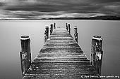 landscapes stock photography | Lake Illawarra Jetty, Lake Illawarra, New South Wales (NSW), Australia, Image ID AU-LAKE-ILLAWARRA-0001. Black and white photo of old jetty at Lake Illawarra in NSW, Australia. Waters at still calm while storm already approaching the lake.