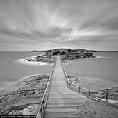 portfolio stock photography | Bare Island Fort , La Perouse, Botany Bay, Sydney, NSW, Australia , Image ID SYDNEY-IN-SQUARE-0013. Bare Island is a heritage-listed islet located in south-eastern Sydney, in La Perouse suburb of Sydney. The islet is located about 16 kilometres south east of the Sydney central business district, within Botany Bay, close to the bay's northern headland. Containing former fortification facilities, Bare Island was a former war veterans' home and museum and is now a historic site that was added to the New South Wales State Heritage Register and is significant as an almost completely intact example of late nineteenth century coastal defence technology. It was designed by Sir Peter Scratchley, Gustave Morell and James Barnet and built from 1881 to 1889 by John McLeod on behalf of the NSW Department of Public Works. Bare Island is connected by a footbridge to the mainland of La Perouse. The heritage-listed military fort and tunnels can only be visited by guided tour. The waters around the island are popular with scuba divers. Bare Island was featured in Mission: Impossible 2 movie and East West 101 TV drama series.