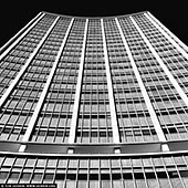 portfolio stock photography | AMP Tower, Sydney, NSW, Australia, Image ID SYDNEY-IN-SQUARE-0023. Located in Circular Quay at the gateway to Sydney's CBD, 33 Alfred Street (also known as AMP Building) has been a prominent feature on the Sydney skyline for 60 years and remains the home and headquarters of AMP to this day. Opened in 1962 by the Prime Minister at the time, Sir Robert Menzies, the AMP 'Sydney Cove' Building, designed by Peddle Thorp & Walker (now PTW Architects), was Sydney's first to break the city's 150-foot (46-metre) height limit, imposed from 1912. At 117 metres, it was Australia's tallest building, almost double the height of anything else in Sydney at the time. 33 Alfred St's post-war International style was unlike anything Sydney had seen before. The twin crescent towers soared 26 storeys, linked centrally into an H-shape and set free from their podium. An observation deck on the top floor was open to the public, offering Sydneysiders and international travellers views of the city and harbour from a never-before-seen angle. Aluminium and glass curtain walling was used to capture magnificent harbour and district views. It was also one of the first buildings to use seawater air conditioning, requiring an on-site 'frogman' to maintain its water-intake pump house.